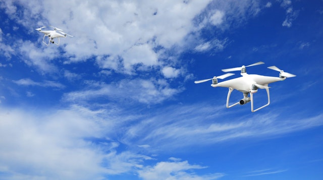 2 quadcopter under blue sky and white clouds 207586