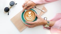 woman holding cup of latte 1260591