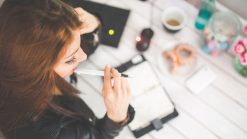 young woman thinking with pen while working studying at her 6384